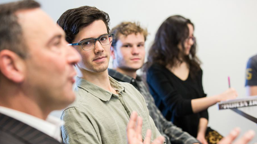 Students in classroom listening to professor talk